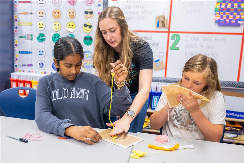 Students learning about embroidery